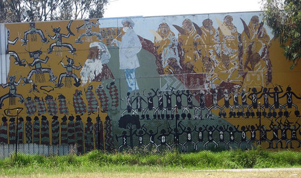 Part of the Northcote Koori Mural at the Aborigines Advancement League, St Georges Road Thornbury, by Megan Evans, Lin Onus, Mr Griggs, Ray Thomas, Millie Yarran, Ian Johnson, Elaine Trott and many other volunteers in 1983. This part of the mural features images by William Barak