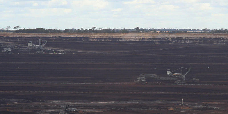 Open cut brown coal mine for the w:Loy Yang Power Station, Victoria, Australia. Two large dredges working coal face, and smaller unit on the mine floor. (Photo: Marcus Wong. Source: Wikipedia)
