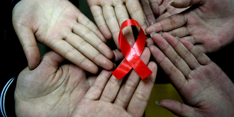 Chinese students show a handmade red ribbon one day ahead of the the World AIDS Day, at a school in Hanshan, east Chinaâ€™s Anhui province on November 30, 2009. (Source: World AIDS Day)