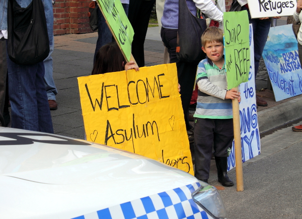A young boy urges Tony Abbott to "save the reef". Photo: Wayne Jansson